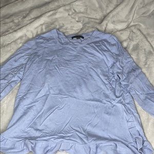 A light blue long sleeve with ruffles